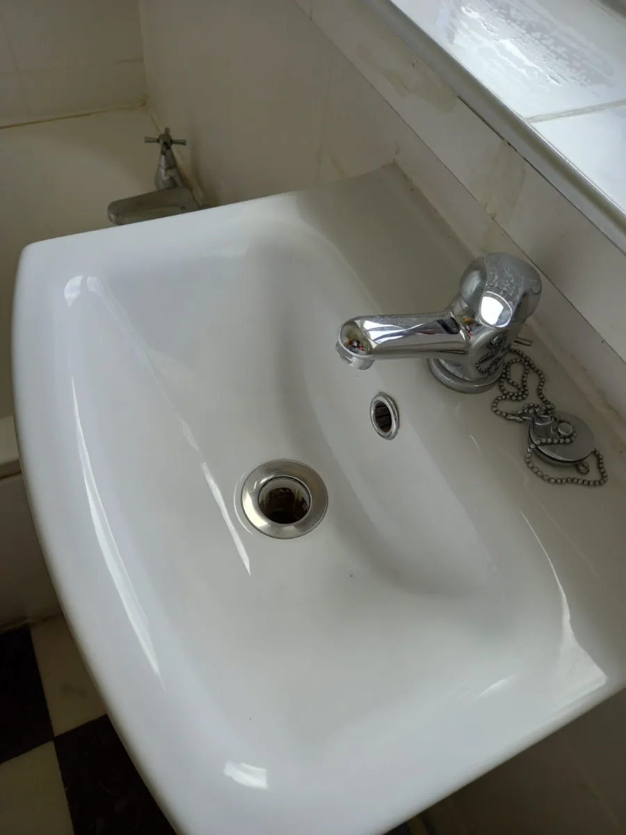 Bathroom sink and faucet scrubbed and polished
