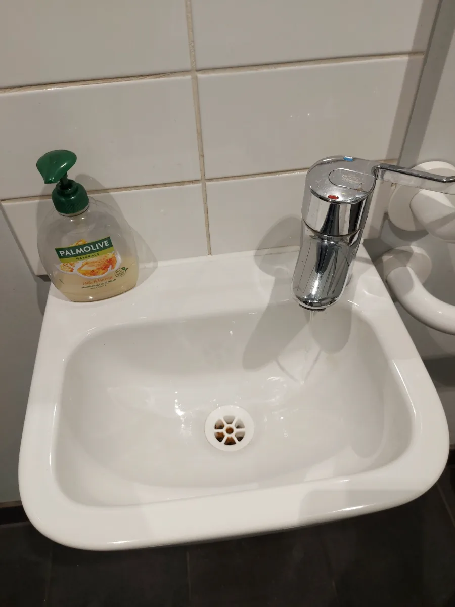Small hand sink and chrome tap cleaned